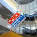 A large Domino's Pizza sign hangs over the Pizza Theater at headquarters in Ann Arbor. Domino's dug through four floors of the headquarters building to open up space.  Melanie Maxwell I AnnArbor.com